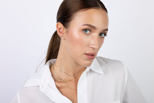 Woman wearing 14k solid gold jewelry - how to care for gold and sterling silver jewelry guide by Massete