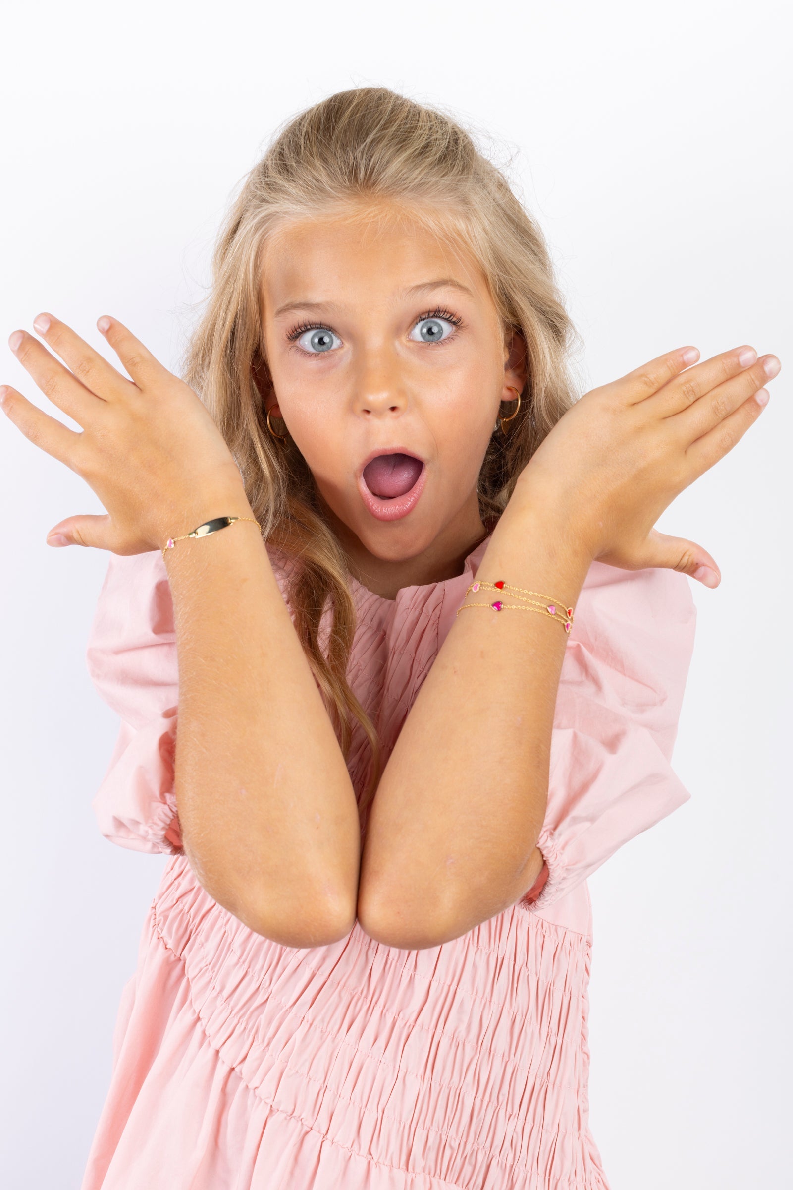young Girl with blonde hair wearing gold bracelets  - Engravable ID bracelets for kids 
