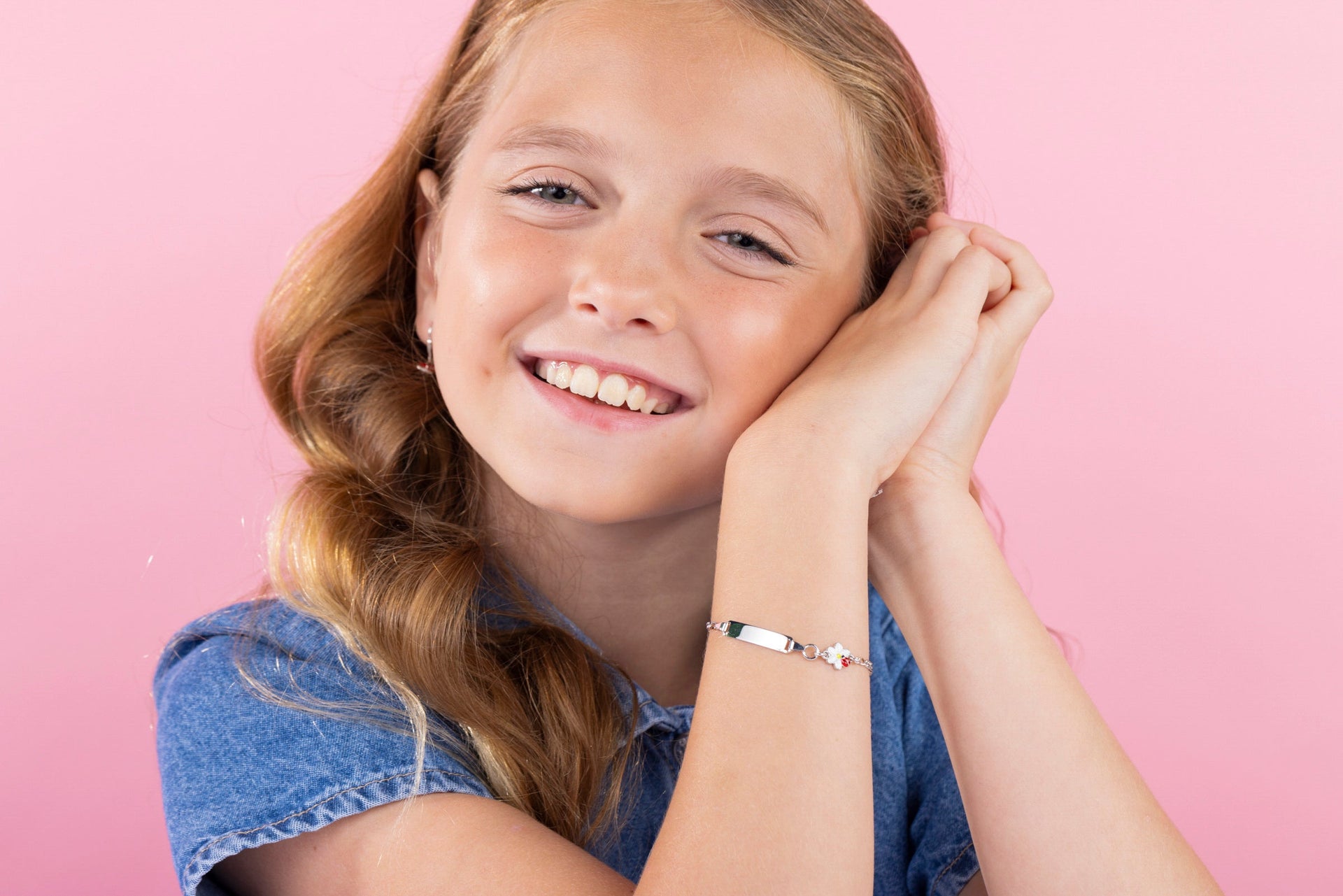 Young girl wearing sterling silver ID name plate bracelet from the Unicornj collection 