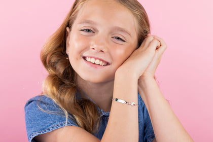 Young girl wearing sterling silver ID name plate bracelet from the Unicornj collection 