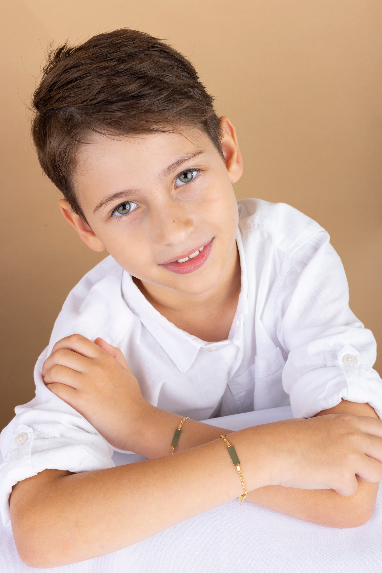 boy wearing 14k gold personalized engraved id bracelet